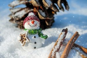 Snowman figure with a red hat and a green scarf.