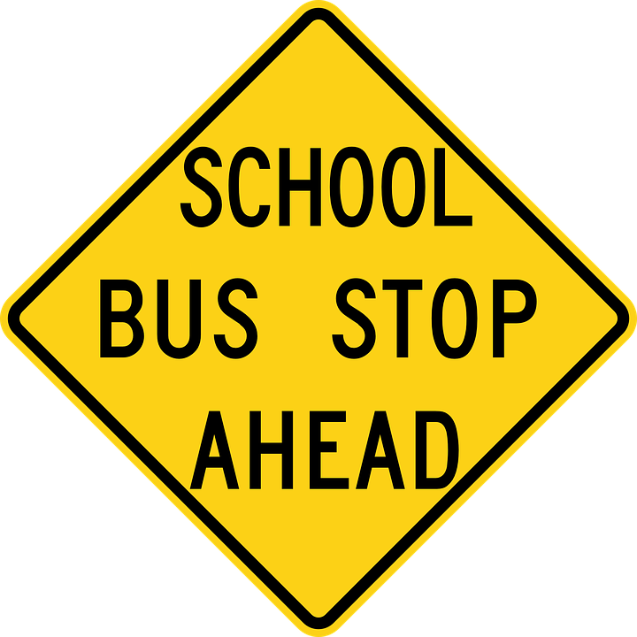 Yellow sign that reads, "School bust stop ahead"